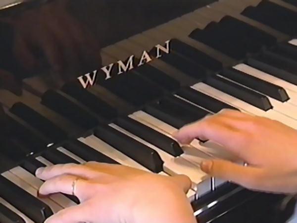 In this screenshot one of the Duggar's is playing on their new Wyman ebony grand piano.